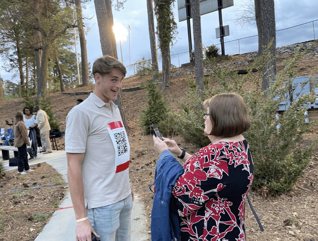 Chowan University Skyler Davies ’24 holds still with the QR code that will take Ministerial Board Member Rev. Anita Thompson to the songs and scripture for the night’s revival service. Chowan Campus Ministry hosted Holy Week Revival Services April 2-5.