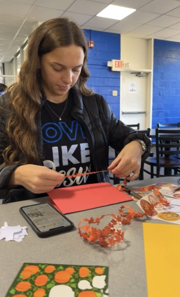 Student makes a card for the homeless.