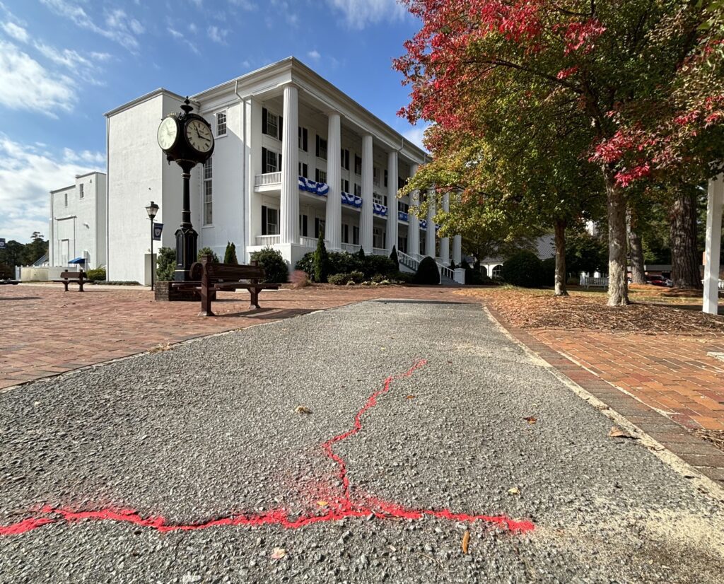 Red Sand in the cracks in front of the Columns building.